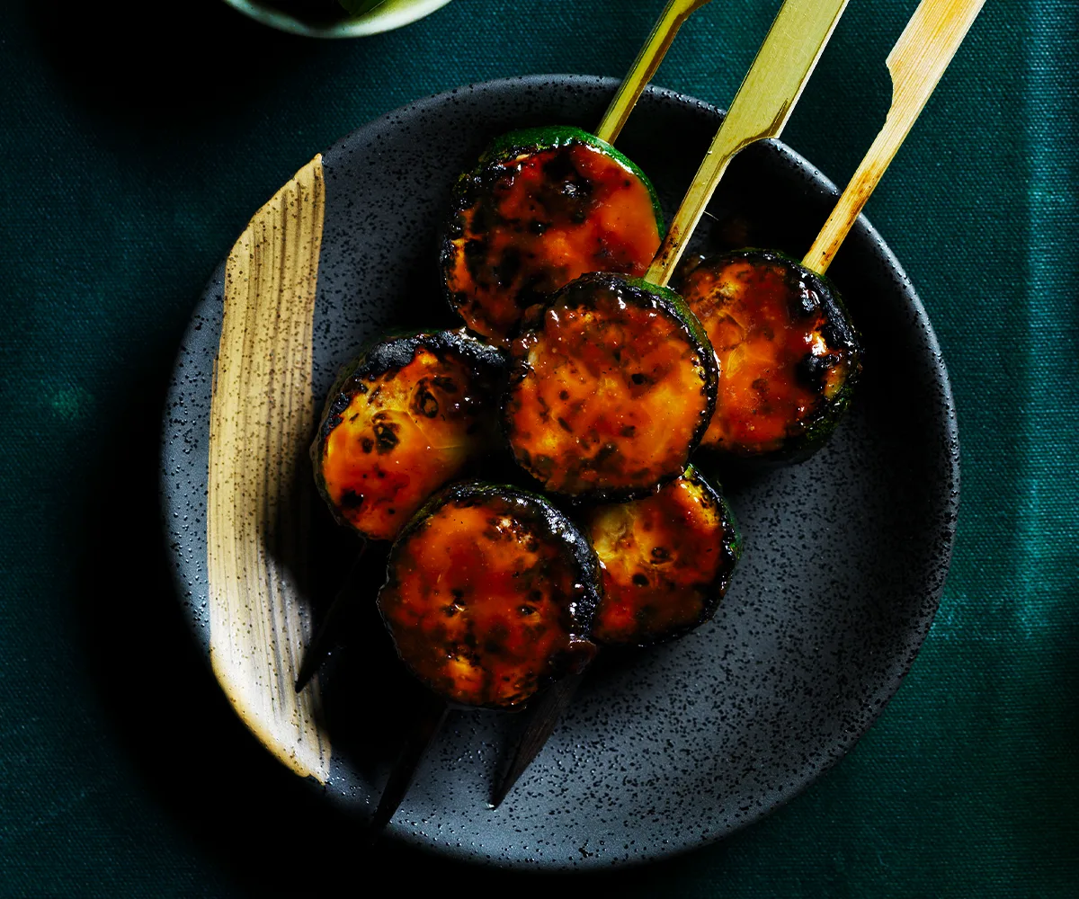 Japanese Zucchini skewers on dark coloured plate