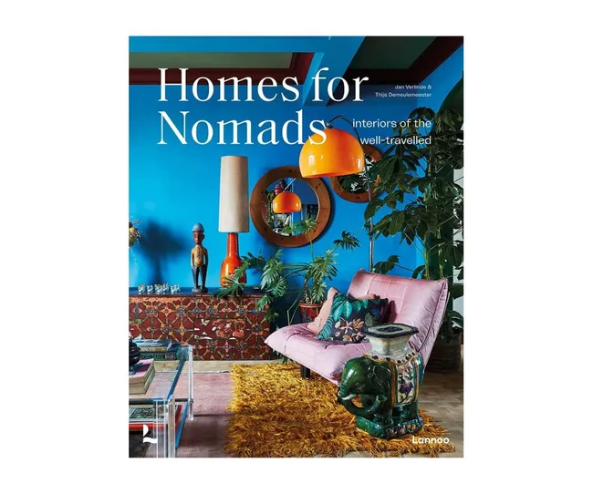 Book cover of "Homes for Nomads" featuring an eclectic, colorful interior with plants and vibrant decor.
