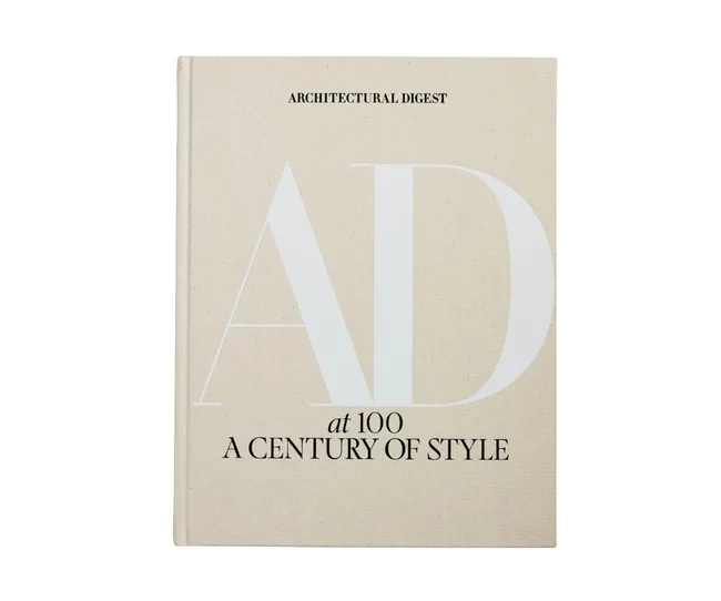 Cover of "Architectural Digest at 100: A Century of Style" book, beige with large "AD" text.