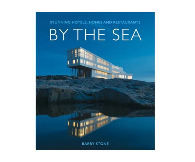"Book cover of 'By The Sea' by Barry Stone, featuring a modern building on a rocky shore at dusk."