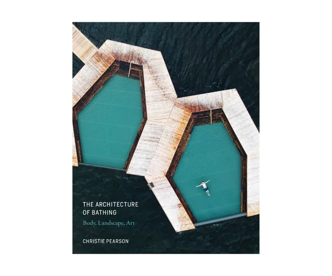Aerial view of floating hexagonal pools on water, featuring one person swimming. Cover of "The Architecture of Bathing."