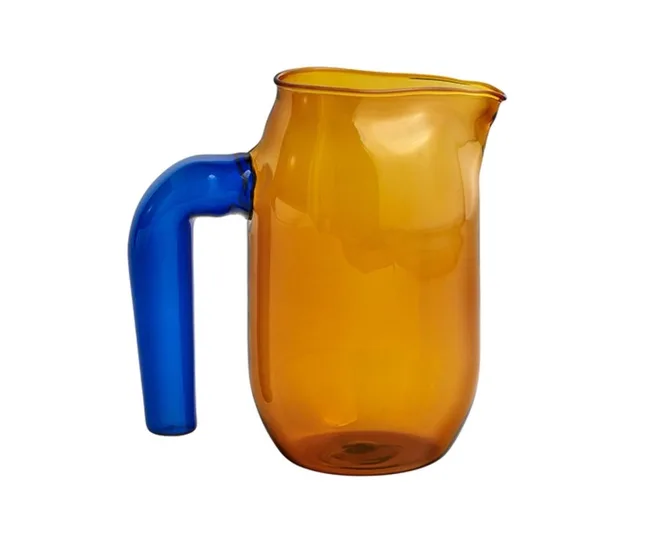 Orange glass pitcher with a blue handle, shown against a white background.