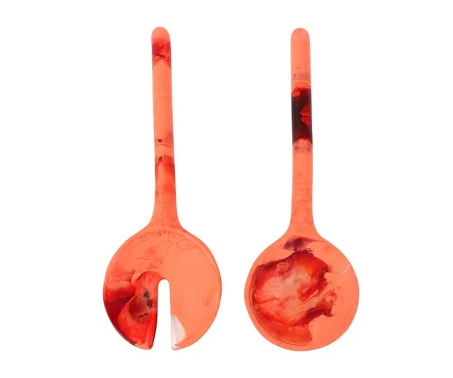 Red and black marbled salad servers; one slotted fork and one spoon.