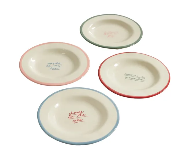 Four ceramic plates with colorful rims and phrases: "apple of my eye," "cool as a cucumber," "cherry on the cake."