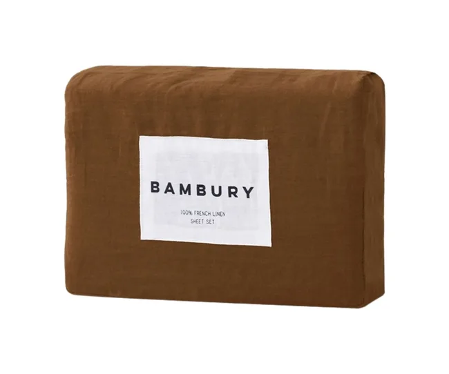 Brown linen sheet set packaging with a white label reading "Bambury 100% French Linen Sheet Set."