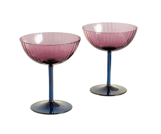 Two elegant pink and blue glass goblets with fluted design, standing side by side.