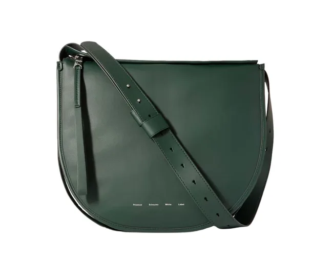 Dark green leather saddle bag with adjustable strap, featuring the text "Proenza Schouler White Label" at the bottom.
