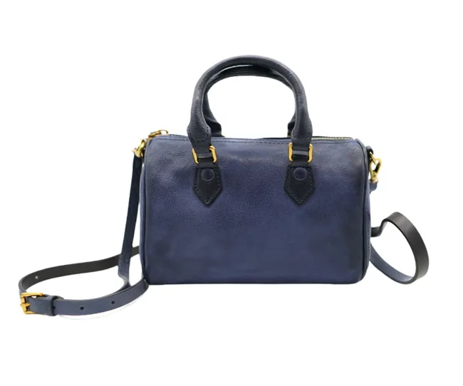 A navy blue leather handbag with gold accents and a detachable shoulder strap.