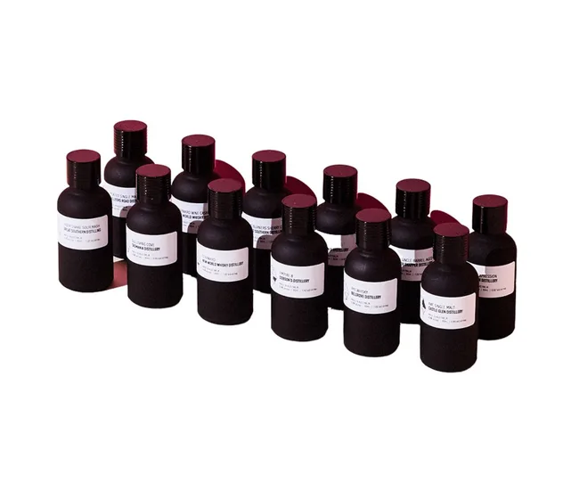 Black bottles with white labels, arranged in three rows on a white background.