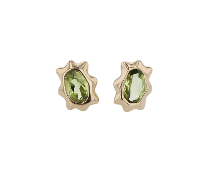 Gold stud earrings with oval green gemstones and wavy edges on a white background.