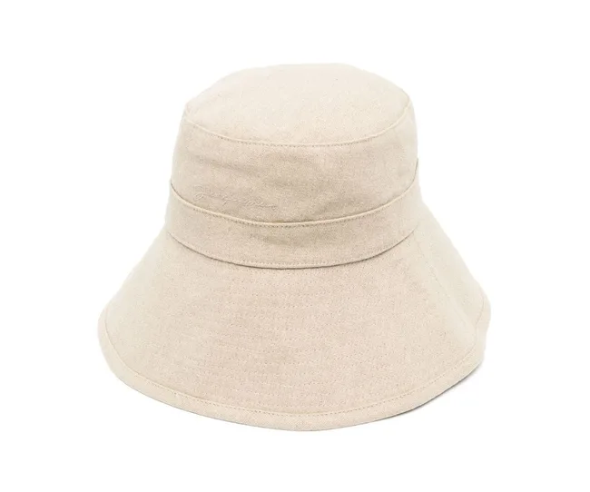 Beige bucket hat with a wide brim and subtle stitching detail.