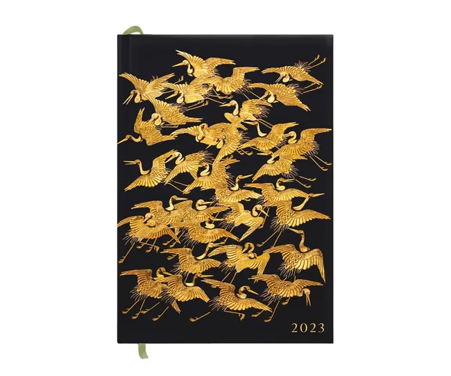 Black 2023 planner with golden cranes embossed on the cover.