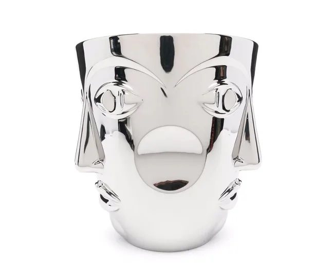 Silver bucket with a stylized face design, featuring exaggerated eyes and nose, glossy finish, reflective surface.