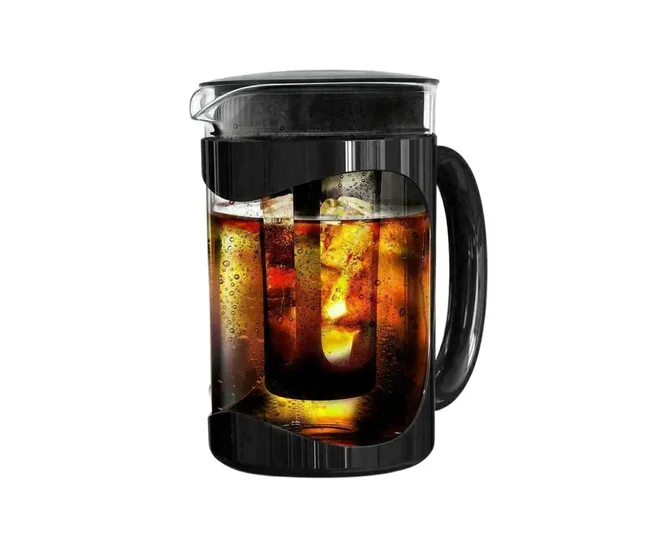Glass pitcher with black handle filled with iced coffee.