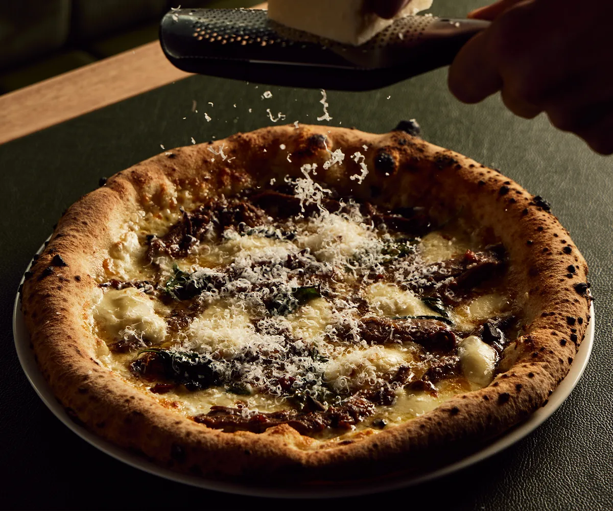 Bandit Pizza and Wine's lamb ragù, pecorino and basil pizza