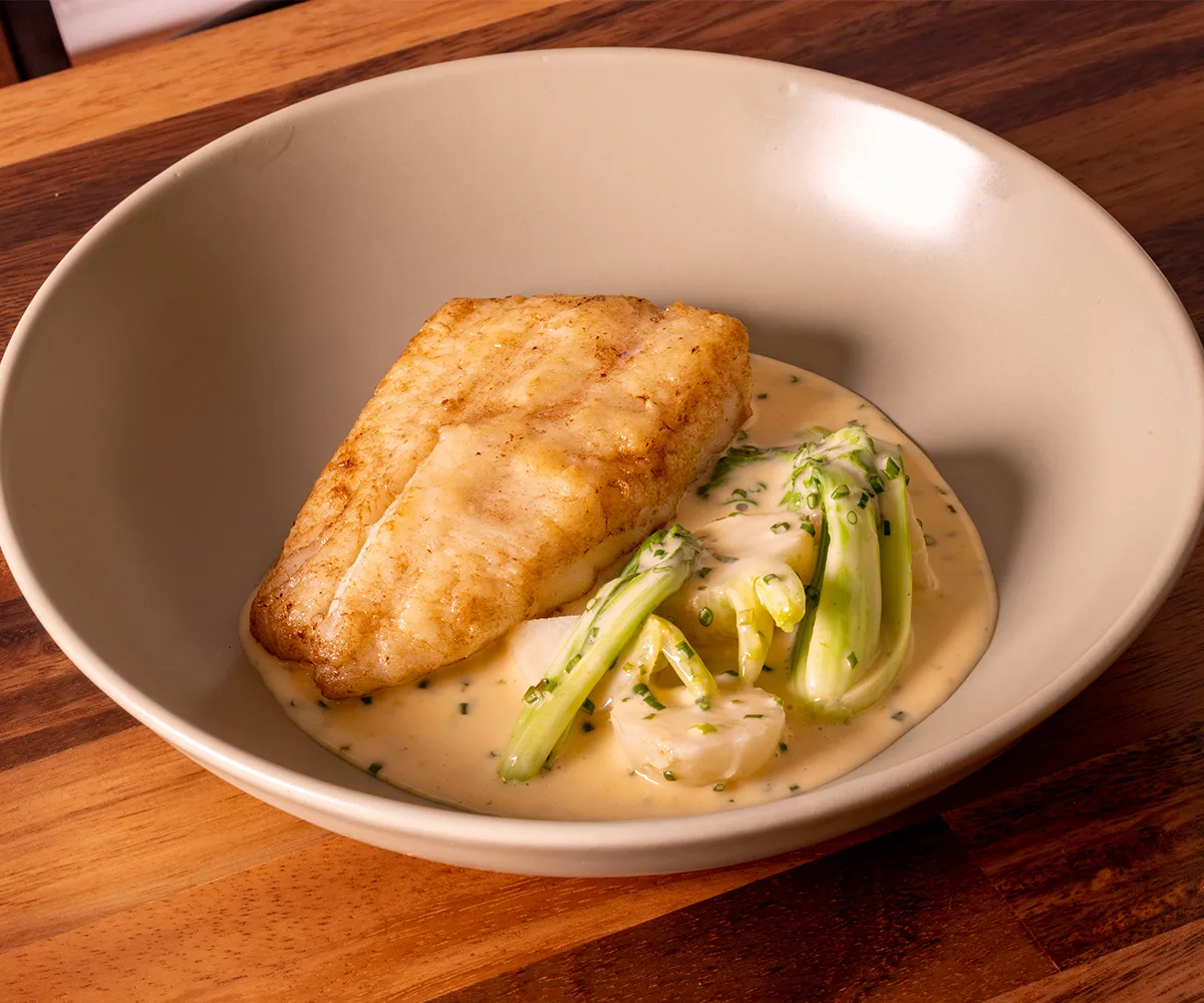 Piece of white fish in a bowl at Clarence in Brisbane