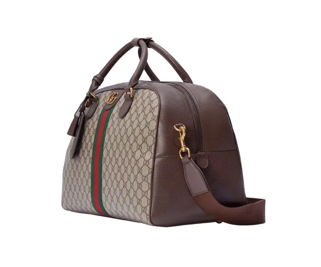 A Gucci monogram canvas and leather handbag with red and green stripe, featuring gold hardware, side view.