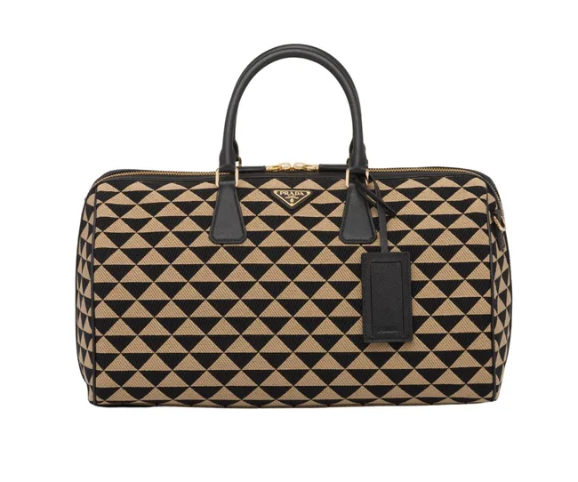 Prada handbag with black and beige triangle pattern and black leather handles.