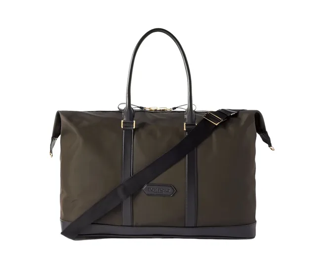 Olive green Tom Ford duffle bag with black straps and handles, featuring gold hardware and a detachable shoulder strap.