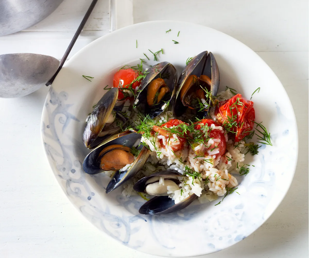 Mussels cooked in a tomato and rice pilaf with dill