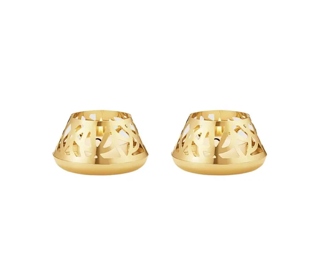 Two gold-toned, intricately designed metal tea light holders on a white background.