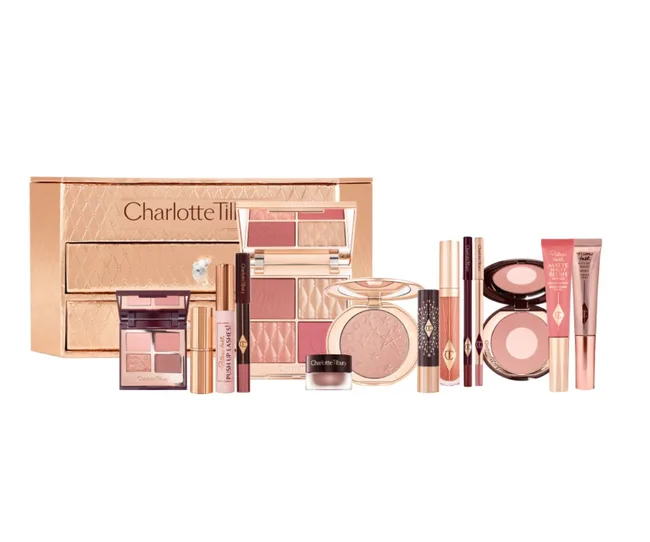 Charlotte Tilbury makeup set with various cosmetic products in rose gold packaging.