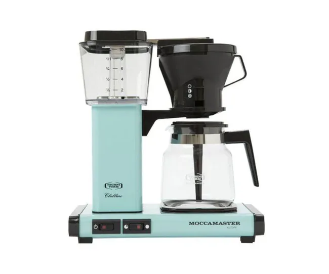 Moccamaster coffee maker in pastel blue with glass carafe and black filter holder.