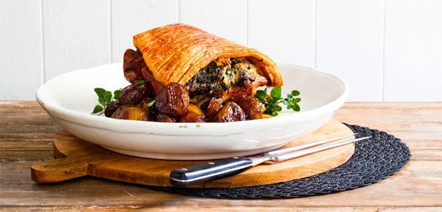 Pork shoulder stuffed with silverbeet, salami and served with agrodolce onions