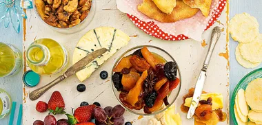 Cheeseboard with spiced nuts and marinated brandy fruits