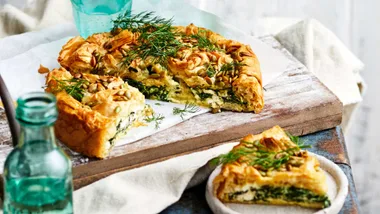 Spinach and feta pie with a slice cut out of it