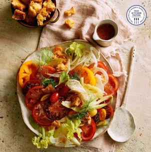 Plate of salad with tomatoes lettuce and croutons