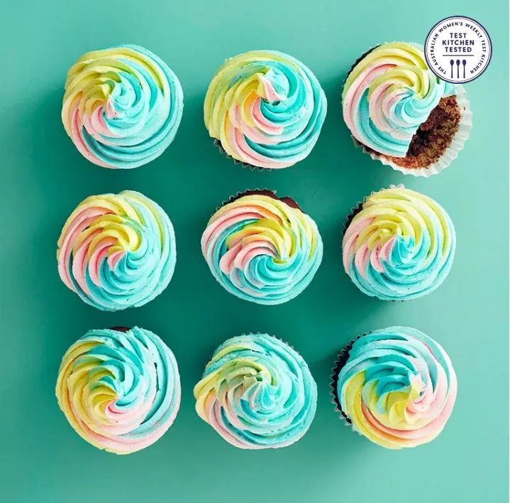 9 chocolate cupcakes with rainbow icing