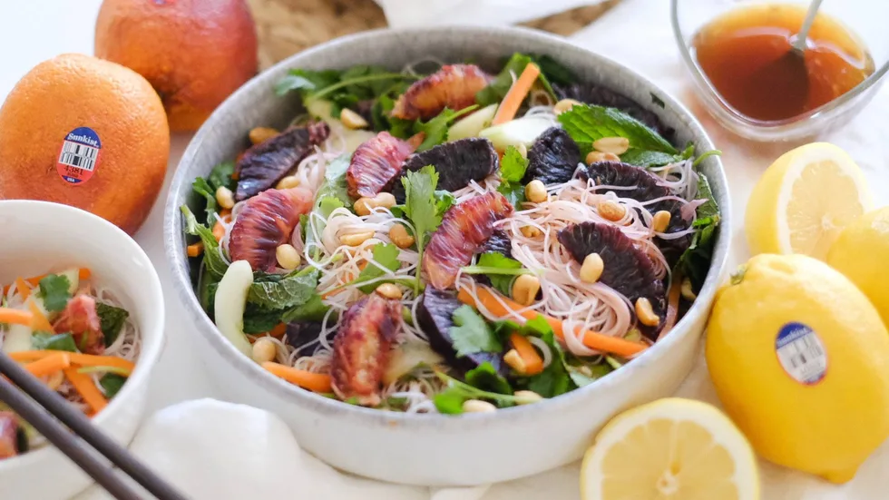 Vietnemese noodle salad in a bowl with blood orange and lemon