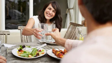 Woman eating barbeque dinner outside
