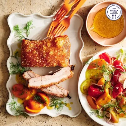 Crispy pork belly with apricot, tomato & fennel salad