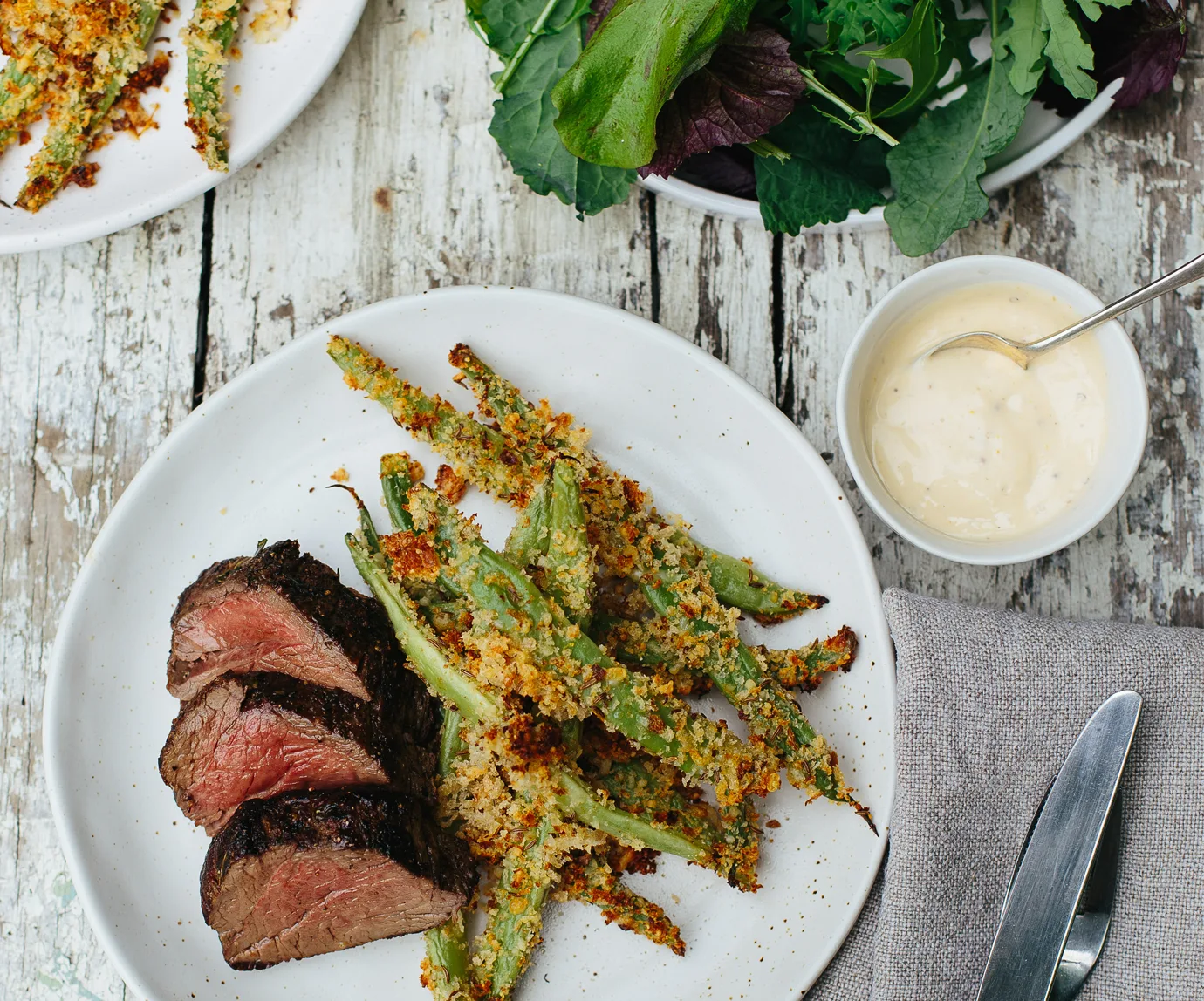 Caraway and parmesan-crusted beans with beef fillet and aioli