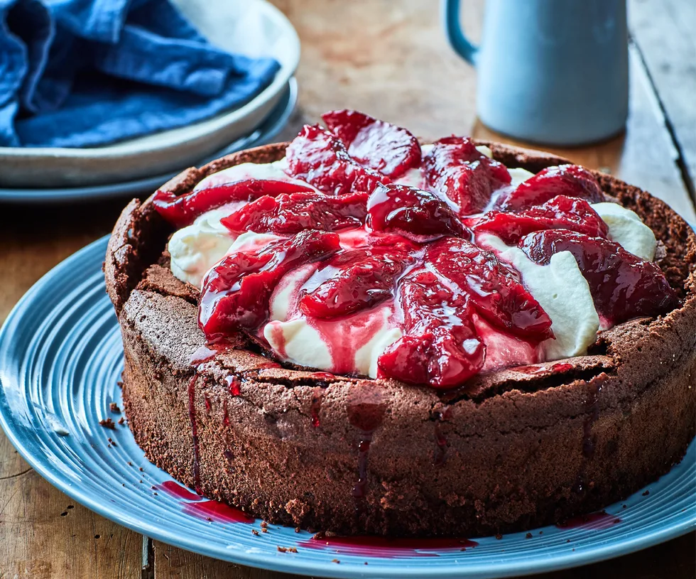 chocolate plum cake with cream on blue plate