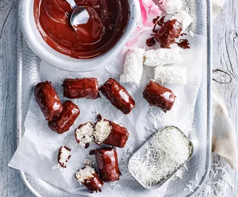 bowl with melted chocolate and bounty bars on tray