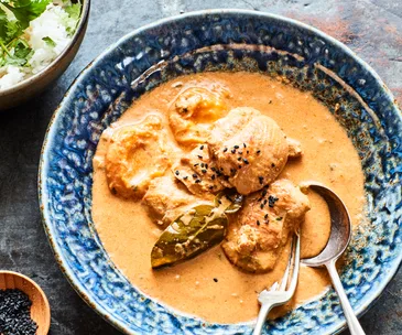 Chicken and apricot curry in blue bowl