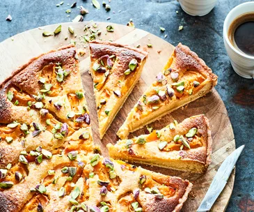 Apricot and pistachio tart on wooden board