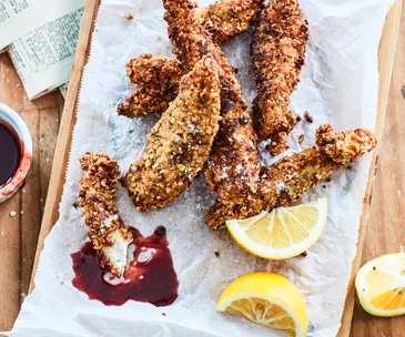 crumbed and fried fish fingers on a table