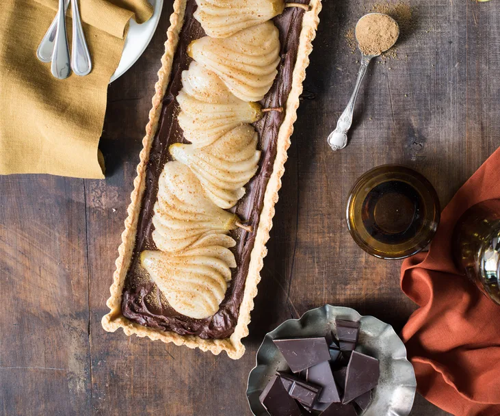 pear and chocolate tart on wooden table