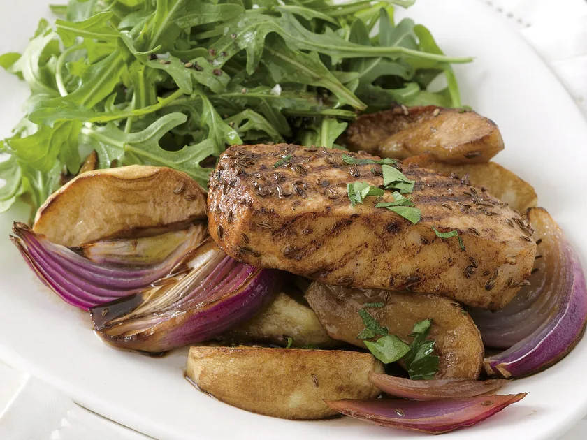 Caraway pork with roast apple and red onion