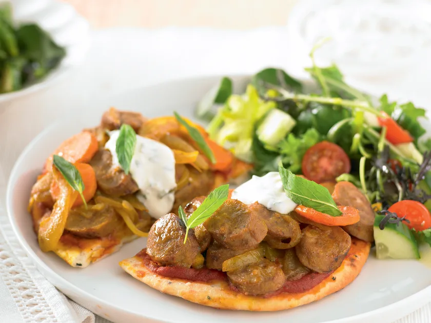Curried sausages on naan