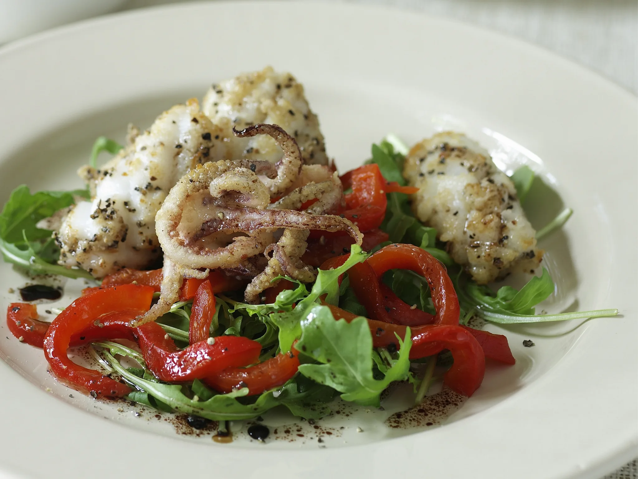 Salt and pepper calamari with roasted capsicum salad