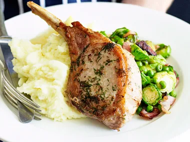 pork cutlets with bacon, brussels sprouts and peas