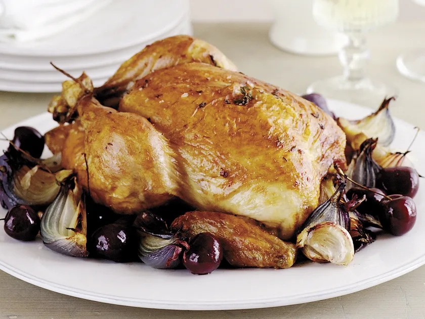 Roast chicken with red onion, garlic and cherries