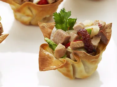 Barbecued duck and lychee in wonton cases