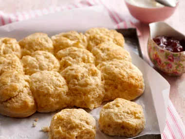 Plate of lemonade scones with bowls of jam and cream