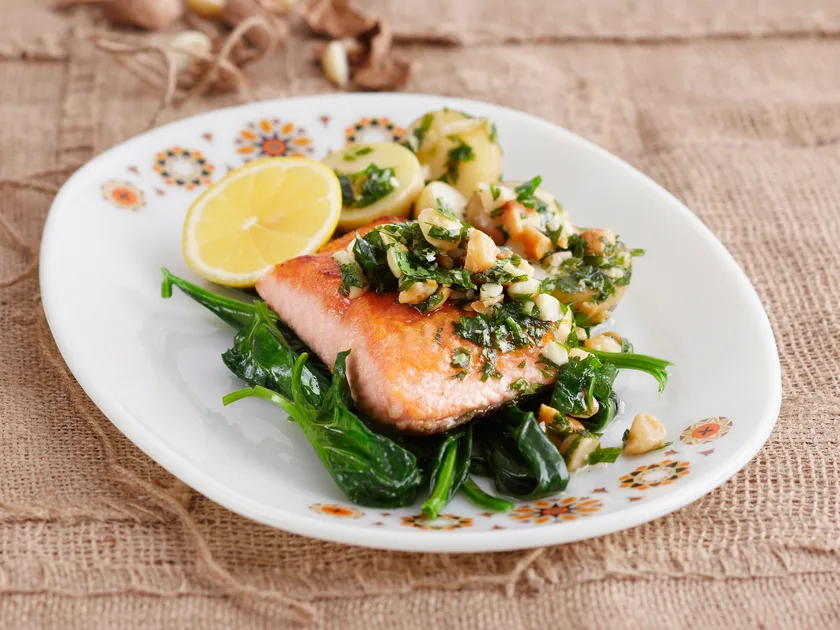 Ocean trout with macadamia salsa and spinach